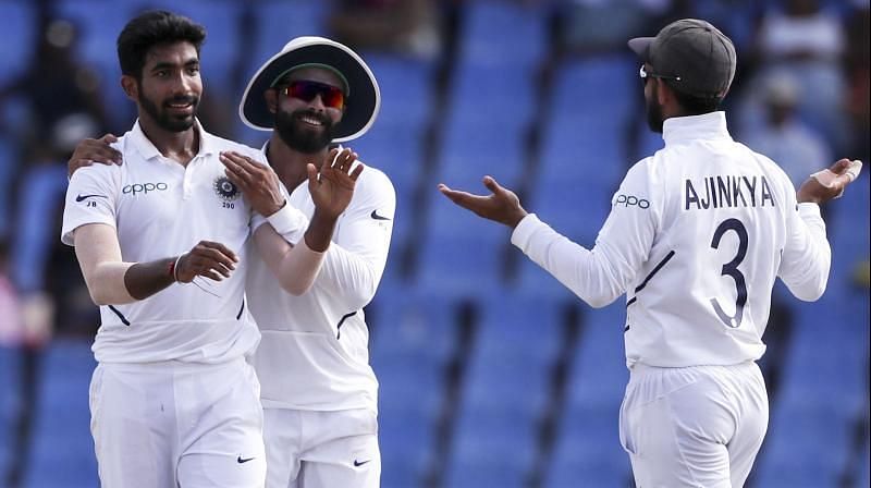 Jasprit Bumrah celebrates a wicket with teammates.