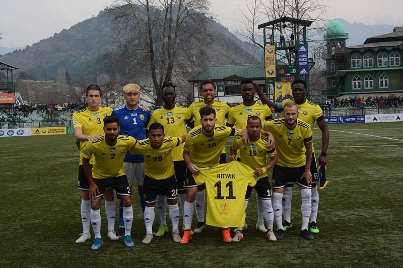 Real Kashmir FC players hold Ritwik Das&#039; jersey while posing for the team photograph