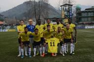 Real Kashmir FC players hold Ritwik Das' jersey while posing for the team photograph