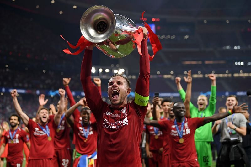 Jordan Henderson hoists aloft the 2018-19 UEFA Champions League trophy.