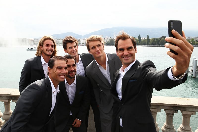 Stefanos Tsitsipas posing for a selfie along with Roger Federer and other teammates