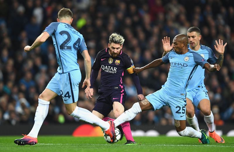 Lionel Messi battles it out with Fernandinho.