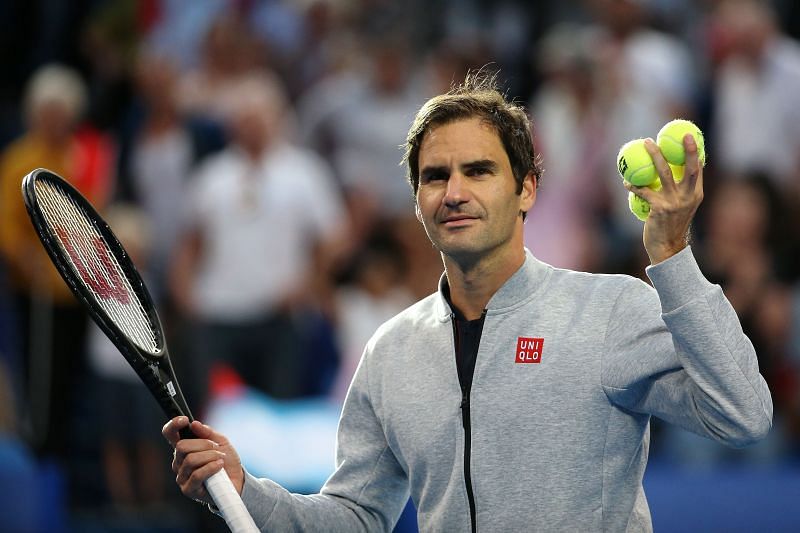 Roger Federer gets ready to toss a ball into the crowd