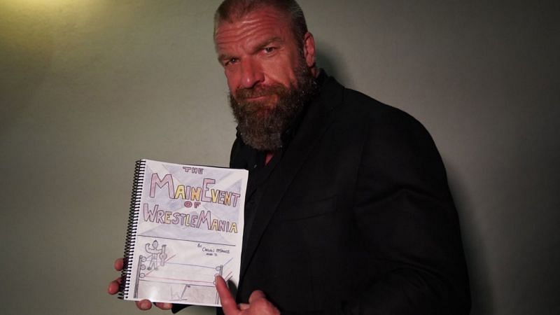 Triple H poses with a copy of the book