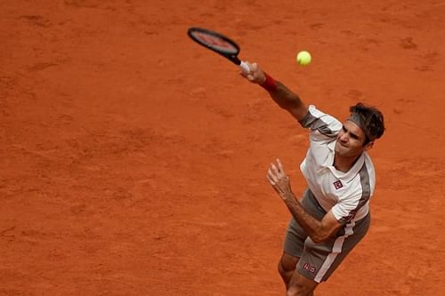 Roger Federer serves during 2019 Roland Garros