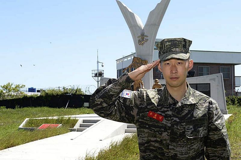 Son salutes after coompleting his military training in South Korea earlier this month