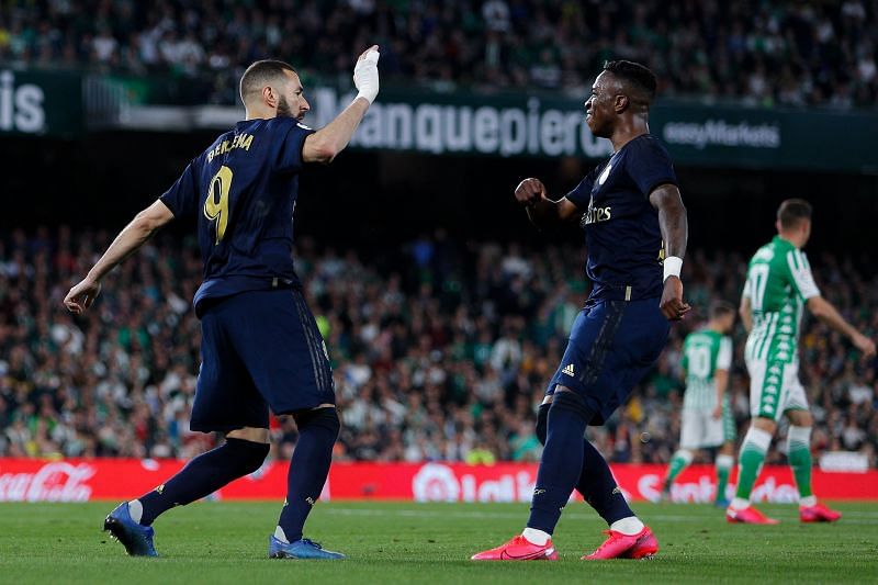 Benzema celebrates with Vinicius after scoring against Real Betis