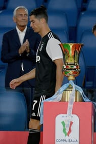 A dejected Cristiano Ronaldo walks away from the Coppa Italia trophy. Juventus were beaten 4-2 on penalties by Gennaro Gattuso's Napoli.