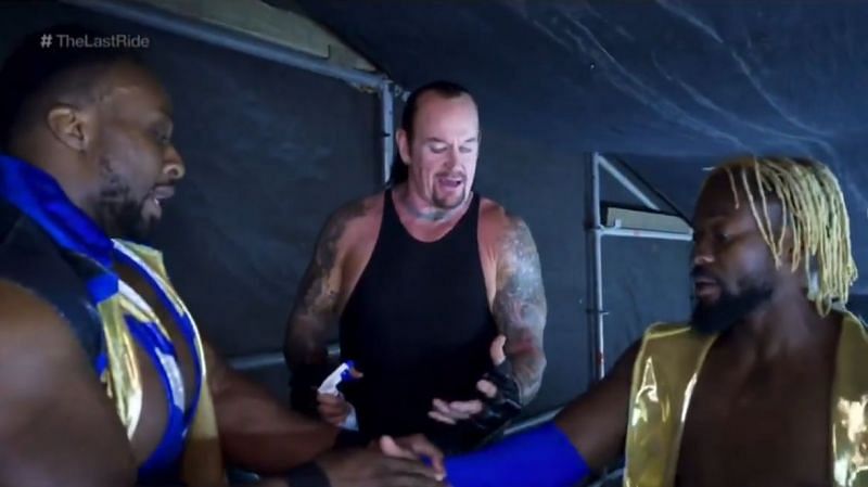 The Undertaker chatting with The New Day in a backstage area, presented in the final chapter of Undertaker: The Last Ride