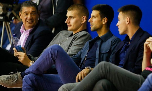 Nikola Jokic (second from left) beside Novak Djokovic at the basketball game