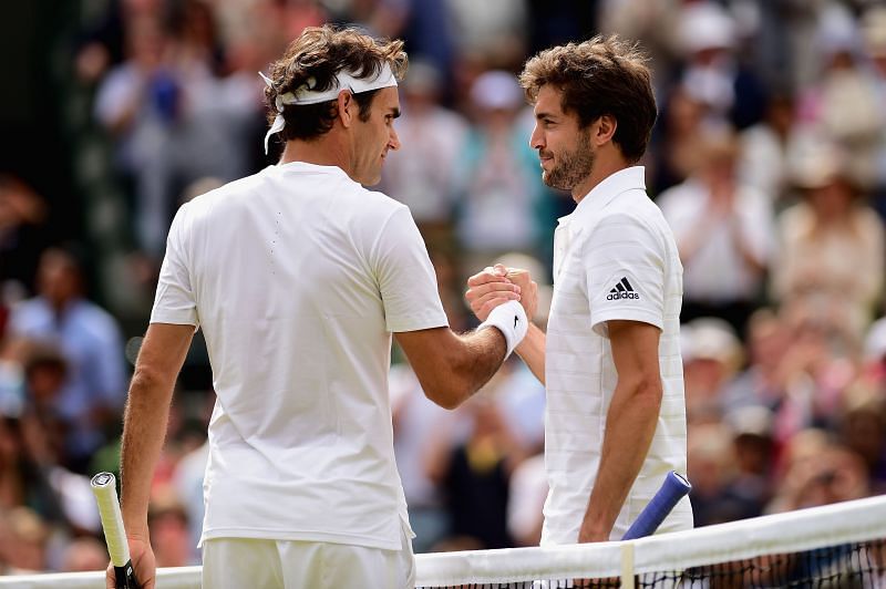 Roger Federer (L) and Gilles Simon