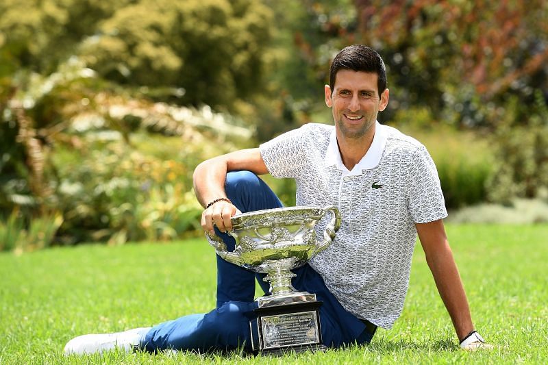 Novak Djokovic poses with the Australian Open trophy earlier this year