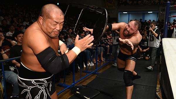 Moxley throwing a steel chair towards Ishii