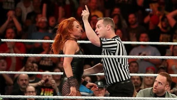 A referee confronting Becky Lynch