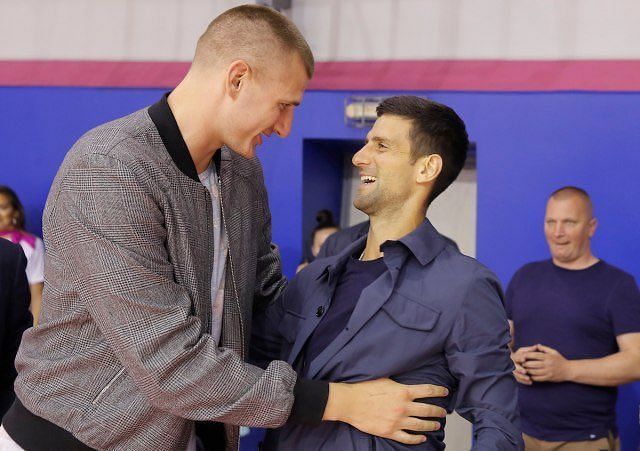 Nikola Jokic (L) and Novak Djokovic sharing an embrace at the game