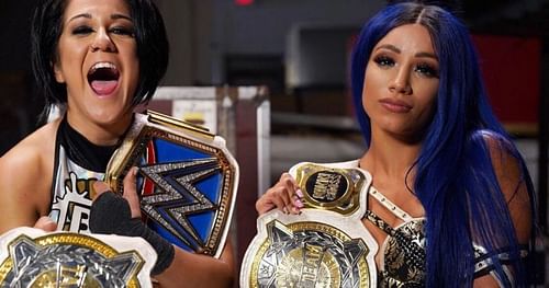 Sasha Banks and Bayley posing with their newly-won Women's Tag Team titles.