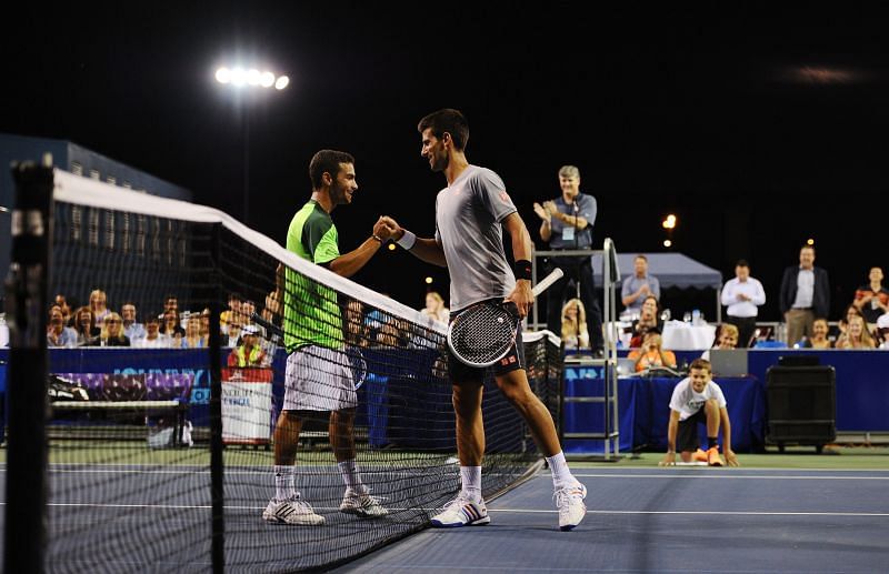 Noah Rubin (L) and Novak Djokovic