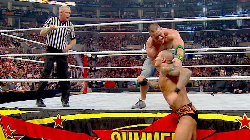 Randy Orton attempting the mid-rope RKO on John Cena