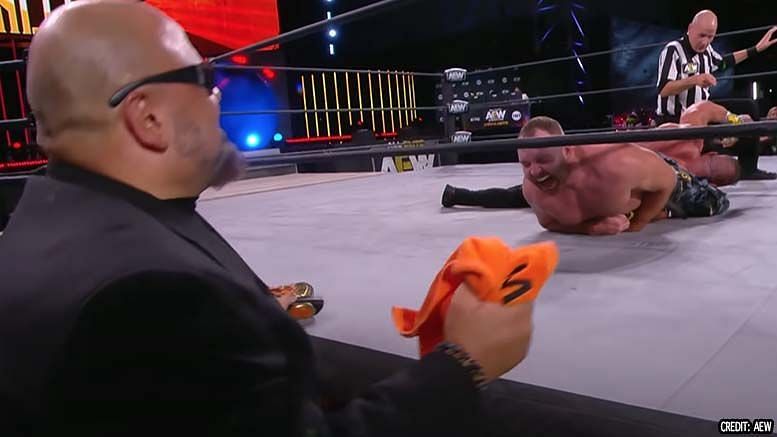 Brian Cage&#039;s arm gets yanked by Jon Moxley as Taz looks on nervously on AEW Fight For The Fallen