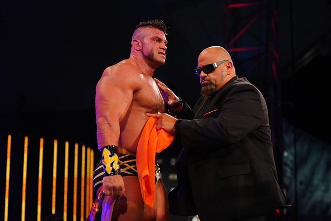 Brian Cage receives the FTW title from Taz on AEW