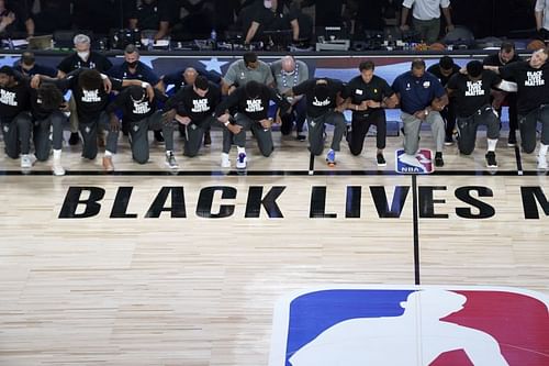 Players kneeling before the first NBA game of the restart