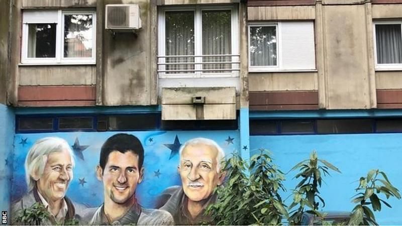 A mural depicts Djokovic outside the flat where he stayed during the bombing of Belgrade in 1999. Credits: BBC