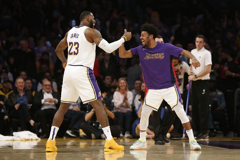 LeBron James celebrates a dunk against the Wolves with LA Lakers teammate Quinn Cook