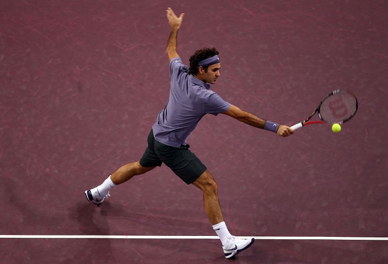 Roger Federer plays a volley