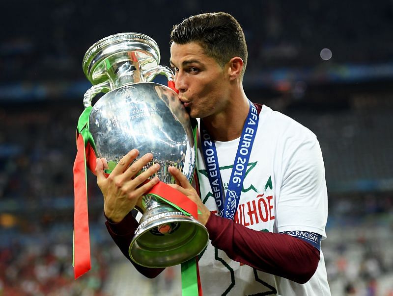 Ronaldo celebrating with the trophy after guiding Portugal to their first-ever international trophy