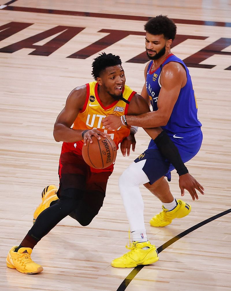 #45 Donovan Mitchell drives past #45 Jamal Murray