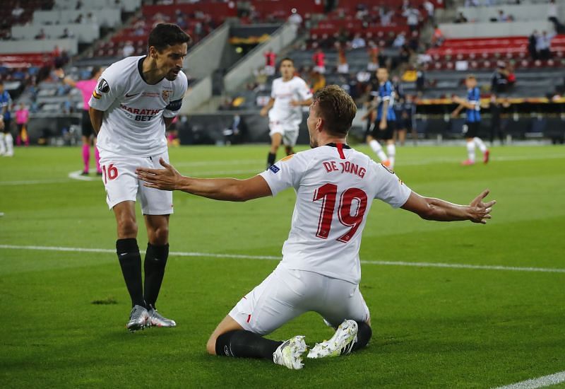 Luuk de Jong of Sevilla FC celebrates with teammate Jesus Navas after scoring his team's first goal 