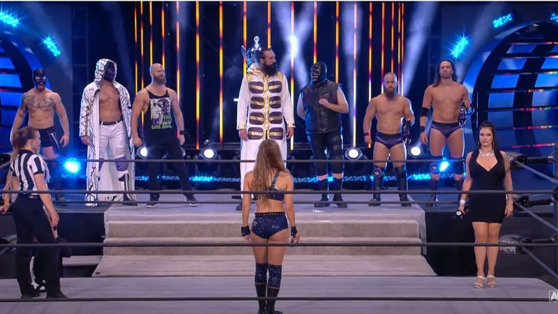 Anna Jay accompanied by The Dark Order before her match.