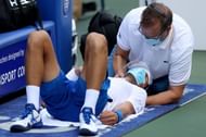 Novak Djokovic receives treatment to his neck during the semifinals