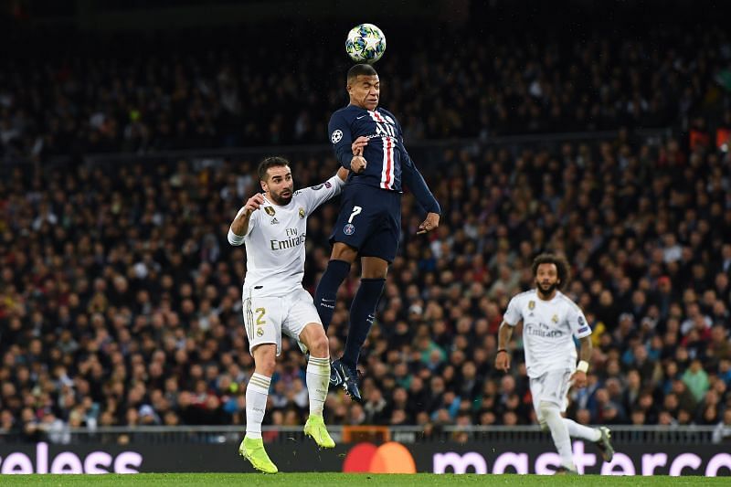 Kylian Mbappe of Paris Saint-Germain competes for the ball with Dani Carvajal of Real Madrid