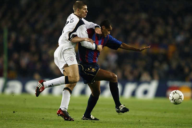Rivaldo battling for the ball with former Liverpool captain Steven Gerrard