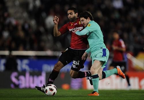 Joao Victor in a tussle with Lionel Messi