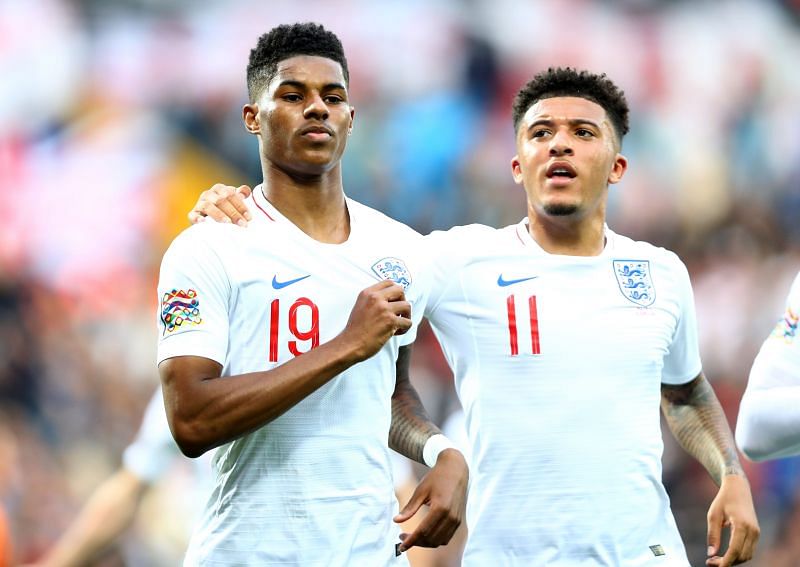 Marcus Rashford of England celebrates as he scores his team&#039;s first goal from a penalty, with Jadon Sancho