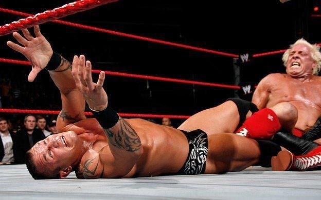 Ric Flair applying the Figure Four Leglock on Randy Orton
