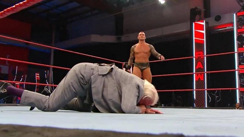 Randy Orton preparing to punt kick Ric Flair. 