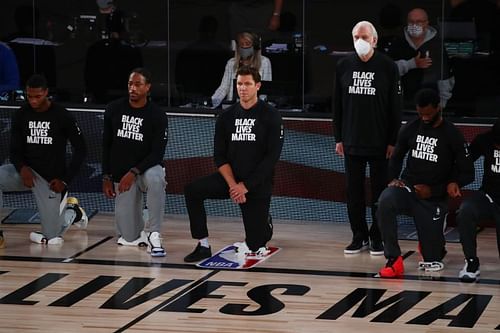 Gregg Popovich stood during the national anthem before today's NBA game.