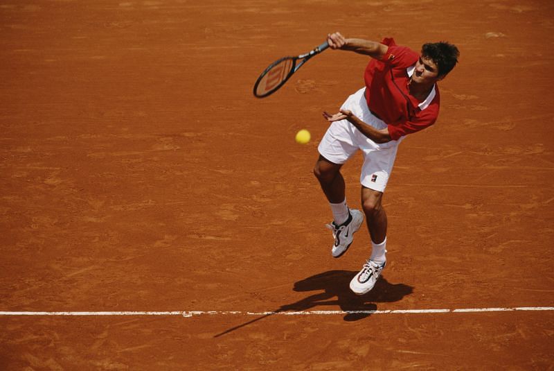 An 18-year-old Roger Federer serves at the French Open