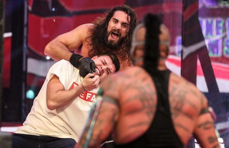 Seth Rollins attacking Dominik Mysterio