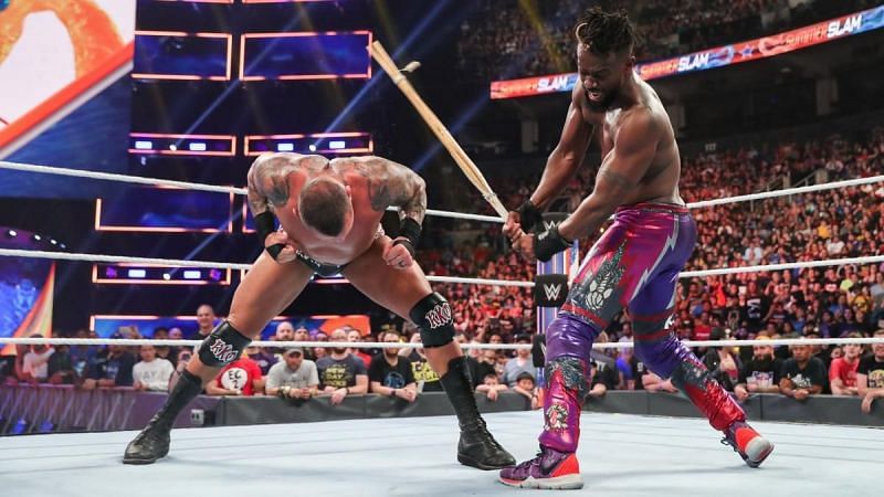 Kofi Kingston hitting Orton with a kendo stick