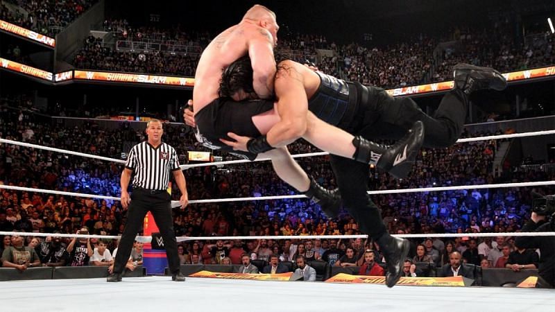 Roman Reigns hitting Lesnar with the Spear