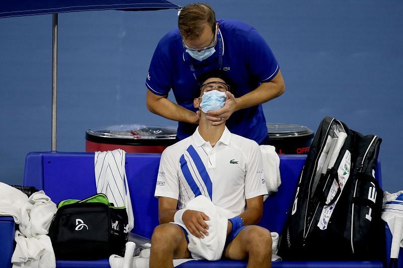 Novak Djokovic getting treatment during his match against Ricardas Berankis