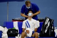 Novak Djokovic getting treatment during his match against Ricardas Berankis