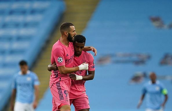 Benzema celebrates his goal against Manchester City with Rodrygo, who left Cancelo for dead beforehand