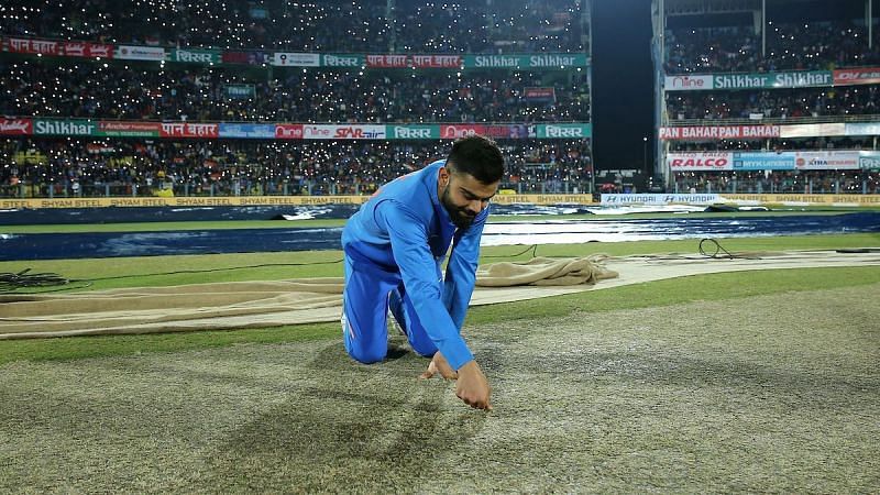 Indian captain Virat Kohli pictured inspecting the pitch ahead of a T20I game
