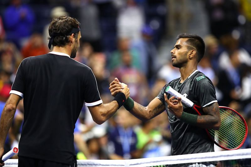 Roger Federer (L) and Sumit Nagal