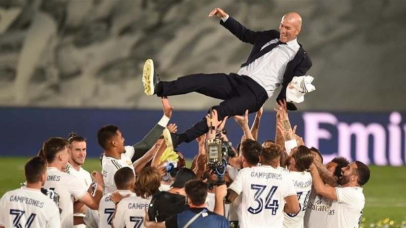 Manager Zinedine Zidane is hoisted aloft by jubliant Real Madrid players